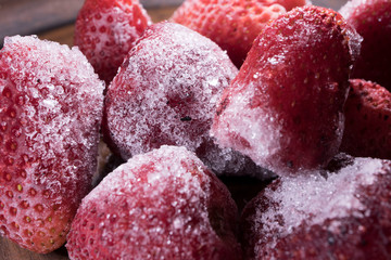 Close-up frozen strawberries covered by frost.