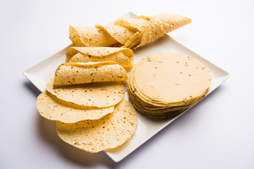 Gujarati papad or papadum in raw dried form with roasted cone, roll and flat variation