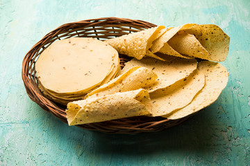 Gujarati papad or papadum in raw dried form with roasted cone, roll and flat variation