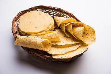 Gujarati papad or papadum in raw dried form with roasted cone, roll and flat variation