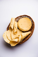 Gujarati papad or papadum in raw dried form with roasted cone, roll and flat variation