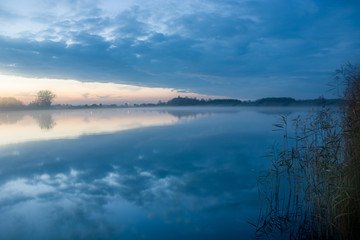 Naklejka na ściany i meble Evening fog over the lake and reeds