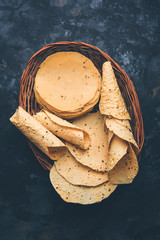Gujarati papad or papadum in raw dried form with roasted cone, roll and flat variation