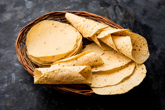 Gujarati papad or papadum in raw dried form with roasted cone, roll and flat variation
