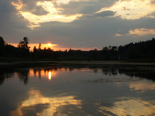 Naklejka premium beautiful sun set on calm lake, red sun, calm lake, quiet evening, Latvia