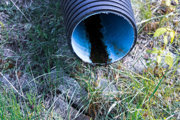 drainpipe against the background of the nature - In the foreground a pipe for discharge of water...