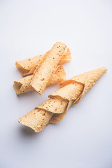 Gujarati papad or papadum in raw dried form with roasted cone, roll and flat variation