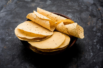 Gujarati papad or papadum in raw dried form with roasted cone, roll and flat variation