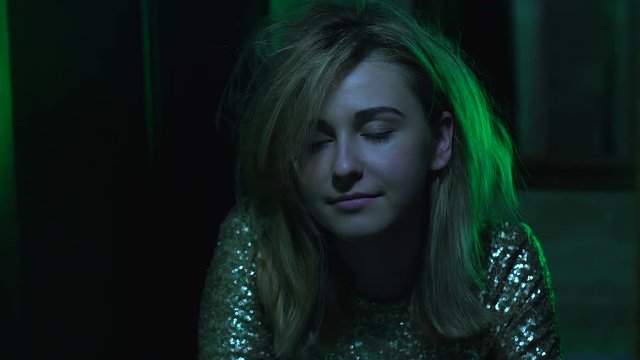 Addicted girl looking in wc mirror, feeling euphoria after drug dose, bad habits