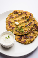 Thalipeeth is a type of savoury multi-grain pancake popular in Maharashtra, India served with curd/butter or ghee