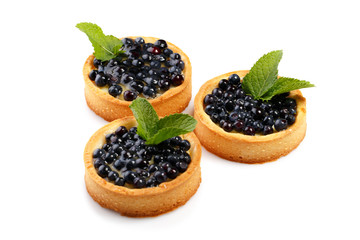 Set of three cakes with blueberry decorated with mint leaves isolated on white background