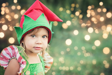 Child waiting for a Christmas in wood in juli. portrait of little children near christmas tree....