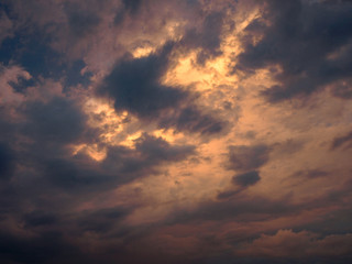 a colorful round storm cloud over a cereal field
