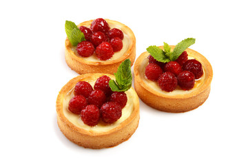 Set of three cakes with raspberry decorated with mint leaves isolated on white background