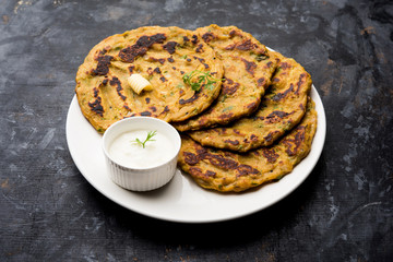 Thalipeeth is a type of savoury multi-grain pancake popular in Maharashtra, India served with curd/butter or ghee