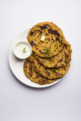 Thalipeeth is a type of savoury multi-grain pancake popular in Maharashtra, India served with curd/butter or ghee