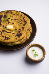 Thalipeeth is a type of savoury multi-grain pancake popular in Maharashtra, India served with curd/butter or ghee