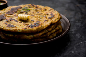 Thalipeeth is a type of savoury multi-grain pancake popular in Maharashtra, India served with curd/butter or ghee