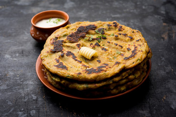 Thalipeeth is a type of savoury multi-grain pancake popular in Maharashtra, India served with curd/butter or ghee