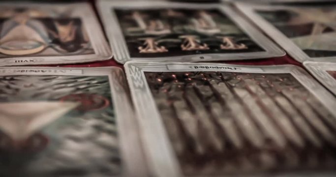 BRUVOLL, NORWAY - MARCH 23, 2011: Closeup of occult mystic tarot deck and old tarot cards laying on table for a magical pagan psychic destiny reading ritual - Concept of supernatural or witchcraft