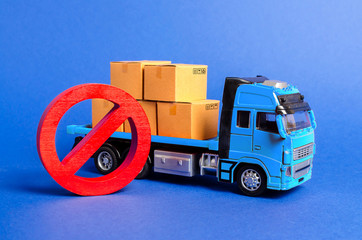 A blue truck loaded with boxes and a red symbol NO. Embargo trade wars. Restriction on importation, ban on export of dual-use goods to countries under sanctions. transport companies. Ban on transit - obrazy, fototapety, plakaty