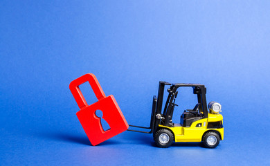 A yellow forklift tilts a red padlock from the road. Bypassing prohibitions and sanctions...