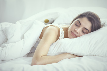 beautiful young woman basking in bed in the morning. Beautiful