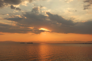 Naklejka na ściany i meble Beautiful sunset with clouds over the Aegean sea