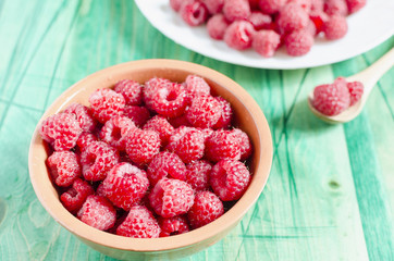 ripe juicy raspberries on a wooden background top view side view