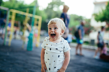 cute little boy shouting outdoor in playground