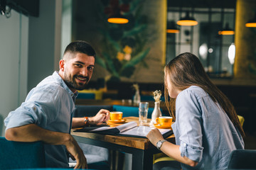 A happy young couple looking at their menu's at a restaurant