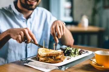 close up of man having dinner or breakfast in restaurant