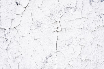 Fototapeta premium Gray Dirty Plaster Wall, With Falling Off Flakes Of Paint. Rough Surface. Old Weathered Painted Background Texture. Vintage Background. Peeled Plaster Wall.