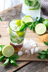 Mohito lime and orange drinks on black background