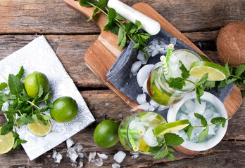 Mohito lime drinks on wooden with blur beach background