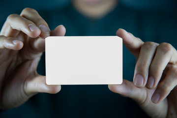 Hand holding  a blank piece of paper. Close up  white business card.