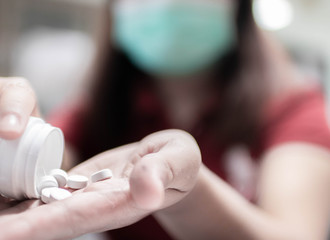 Patients are sick, pouring medicine into their hands to take medicine. In the picture there is a blur to be used as a background.