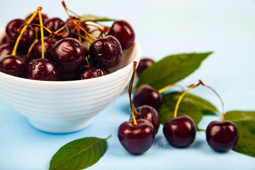 Ripe sweet cherry in a white bowl
