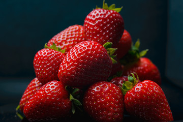 Strawberry closeup. Macro image of fresh strawberries on dark background