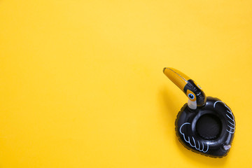 Pelican summer inflatable holiday pool toy against a bright yellow background