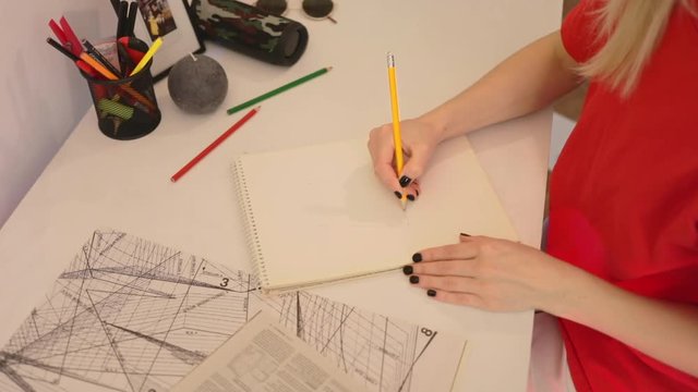 Close up woman draws a pencil on paper. Female fashion designer drawing sketches the dress. Fashion designer drawing and paint. Study design tutorial animator illustrator work freelance wedding