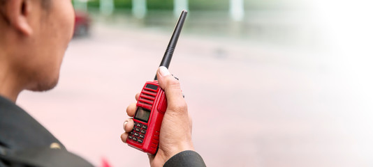 Security guard uses radio communication for facilitate traffic. Traffic Officers use walkie talkie...