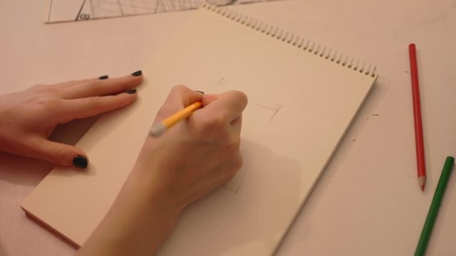 Close up student draws a pencil on paper. Female fashion designer drawing sketches the dress. Fashion designer drawing and paint. Study design tutorial animator illustrator work freelance wedding