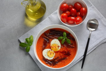 Traditional Spanish andalusian tomato cream soup Salmorejo served with egg, ham jamon in a bowl. Summer cold soup concept 