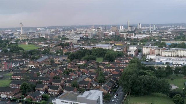 Aerial cityscape across Liverpool city buildings, cathedral, radio city tower along skyline. Ascending aerial view.