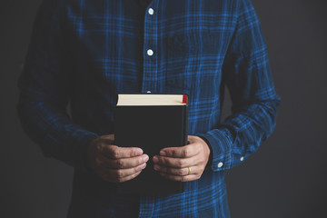 Man is holding and hug the bible in the morning. Hands folded in prayer on a Holy Bible in life concept. worship and religion. copy space