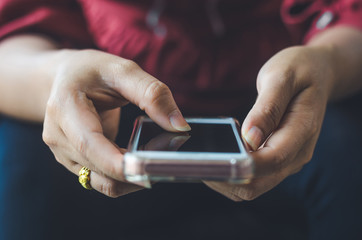 hipster woman using hands touching and typing on mobile phone screen search internet online working or social communication with digital technology app device in coffee shop indoor vintage lifestyle.