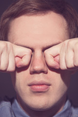 man covering face with his both hands