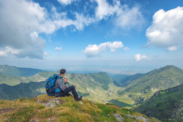 Successful active man hiker on top of mountain enjoying the view. Travel sport lifestyle concept