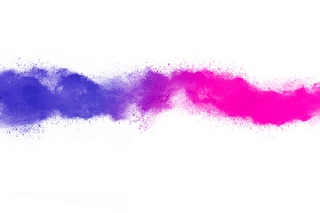 Freeze motion of purple color powder exploding on white background.